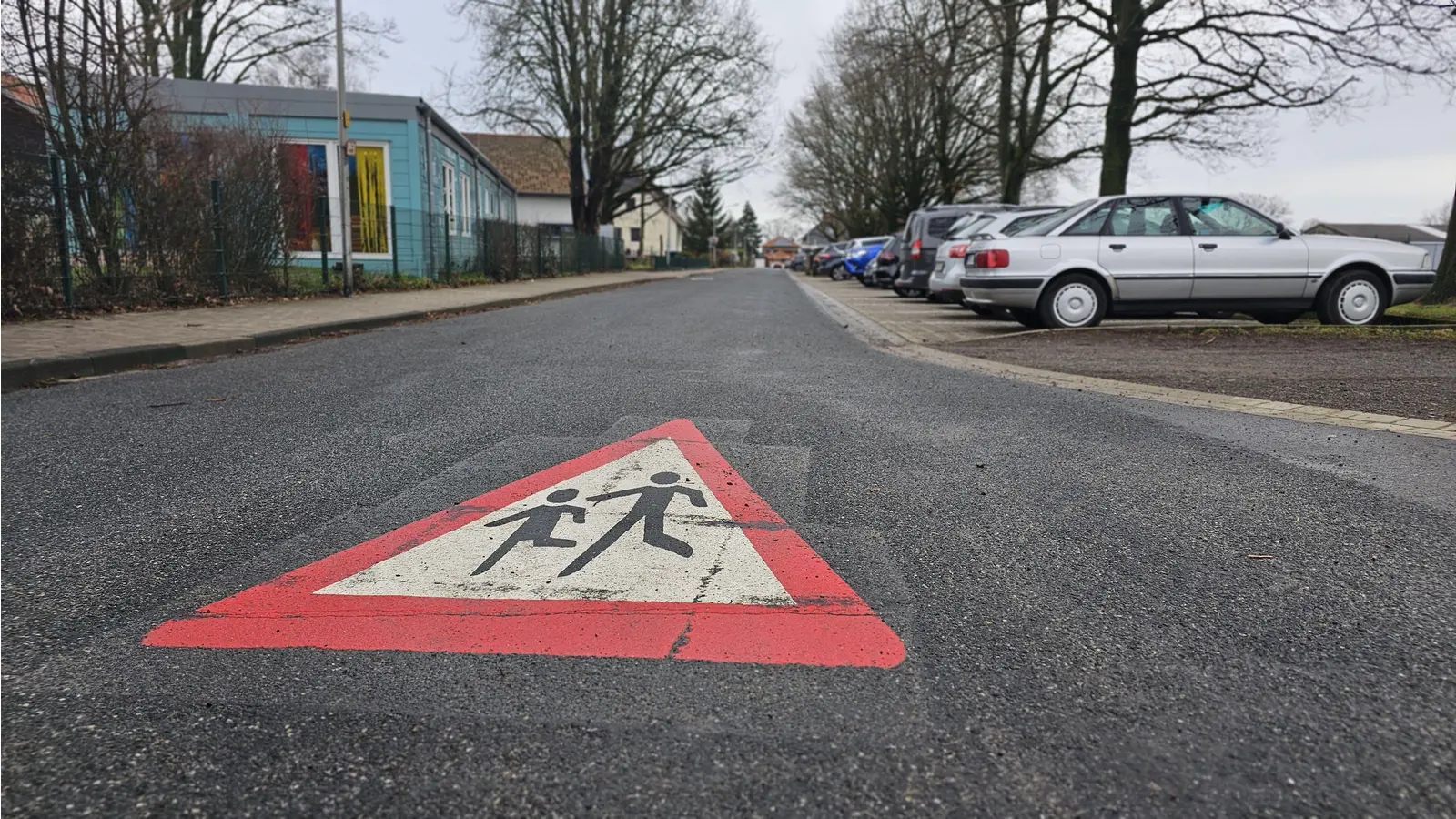 Das hält die Verwaltung für ausreichend: Eine Markierung „Achtung Kinder” auf der Schulstraße. (Foto: tau)